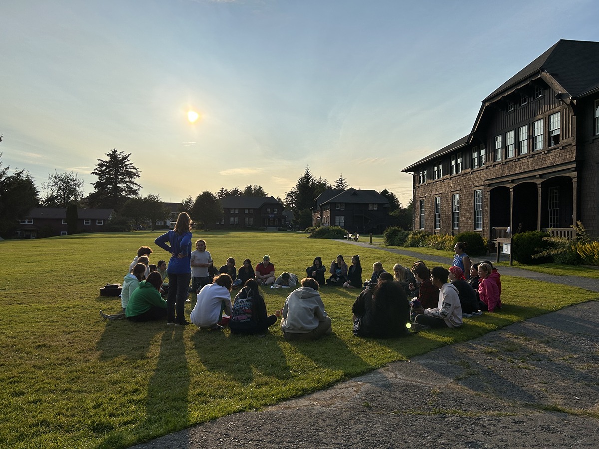 Summer Seminar 2023 students gather for a Student Body meeting on the lawn.